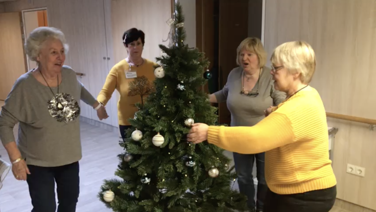 Vier Bewohnerinnen schmücken einen Weihnachtsbaum
